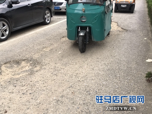 市區(qū)慎陽(yáng)路西段道路坑連坑  居民追問何時(shí)能修